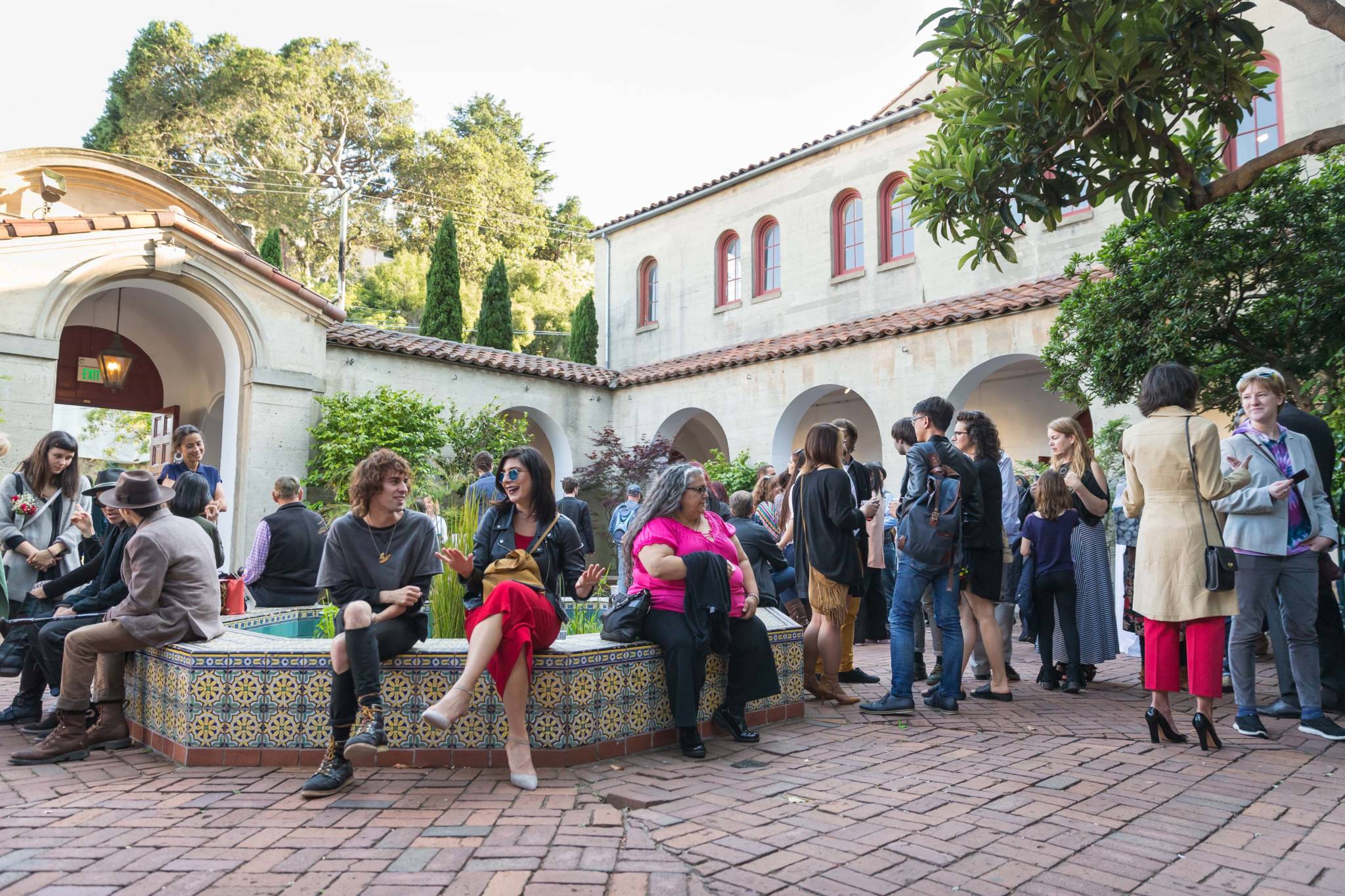 Crowds in the North Beach campus' courtyard during SFAI's 2016 commencement celebrations.