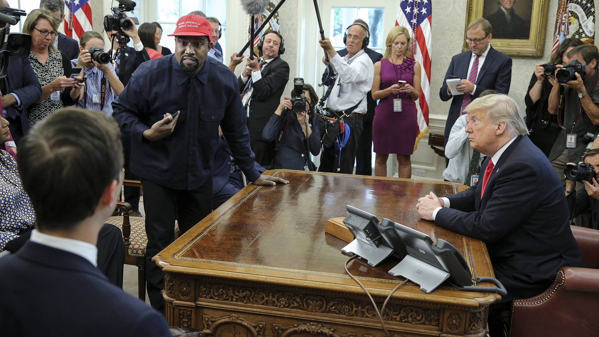 Kanye West stands up as he speaks during a meeting with Donald Trump in the Oval office of the White House on October 11, 2018 in Washington, DC.  Oliver Contreras - Pool/Getty Images