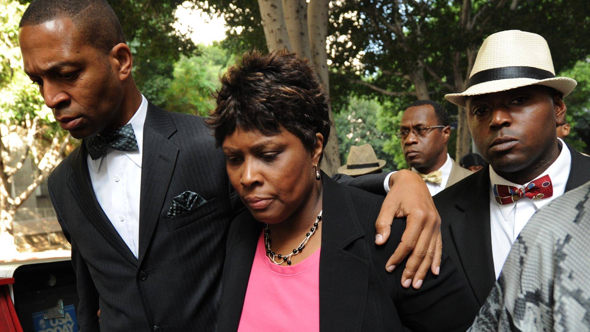Wanda Johnson (center), the mother of Oscar J. Grant III, walks with supporters as they leave the Los Angeles Superior Court after the involuntary manslaughter verdict against former Bay Area Rapid Transit (BART) officer Johannes Mehserle, in Los Angeles on July 8, 2010. MARK RALSTON/AFP/Getty Images