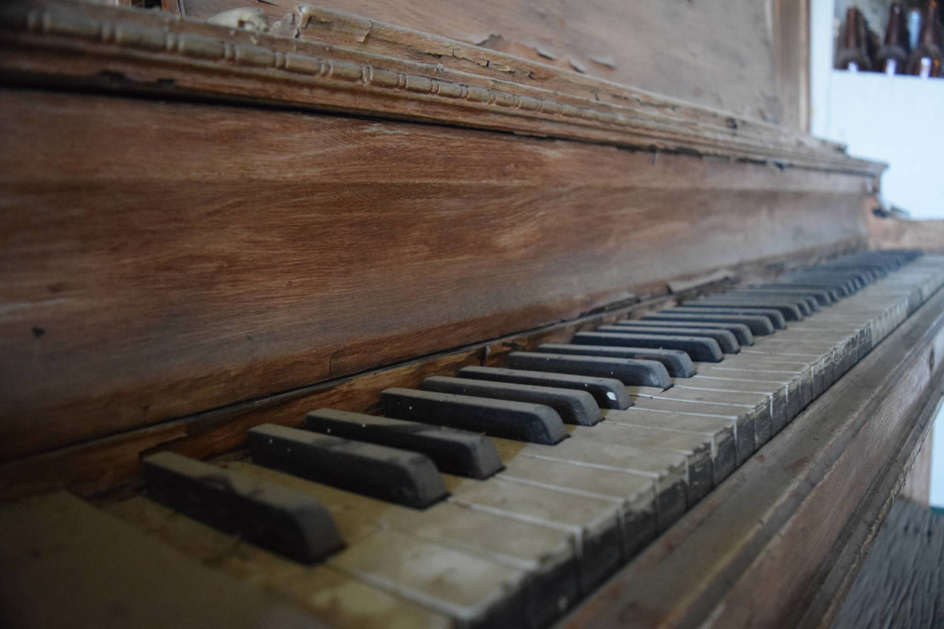 A piano lies dusty in the ghost town of Bodie—one of the subjects of this year's most-heard podcasts from KQED. Carly Severn/KQED