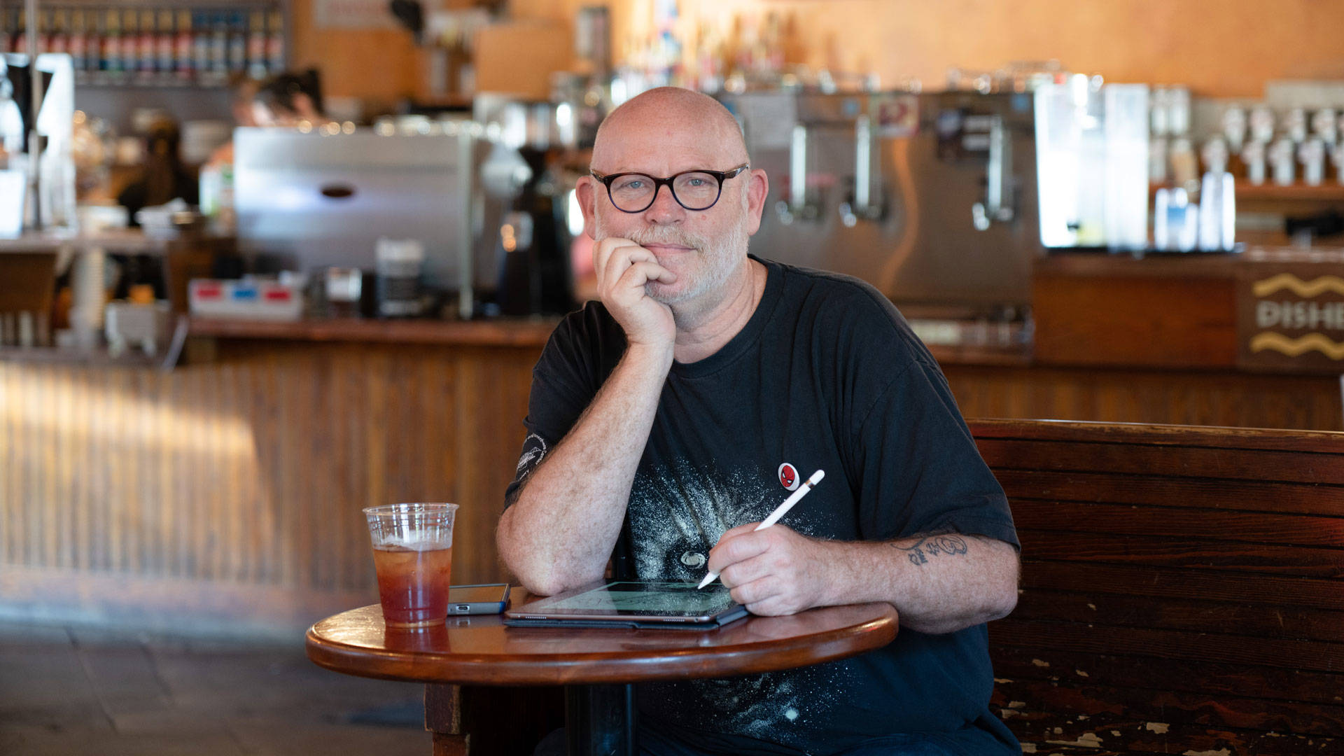 Cartoonist Tom Beland at Aroma Roasters in Santa Rosa. Beland considers the $300 he spends every month at Santa Rosa cafes "studio rent." Graham Holoch/KQED