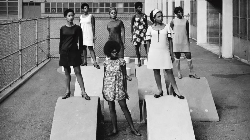Black-and-white image of Black women in mod-style clothes standing on concrete ramps