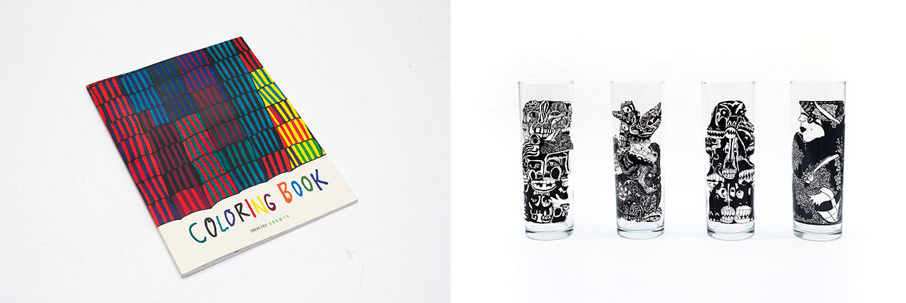 A coloring book cover and four tall clear glasses with intricate black line drawings on them.