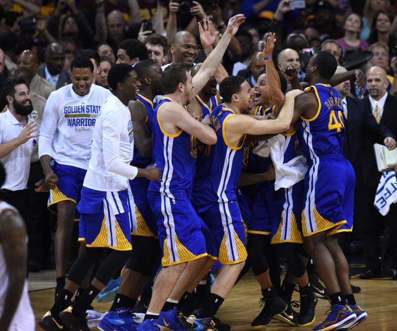 The Golden State Warriors celebrate at the end of Game 6 of the 2015 NBA Finals on June 16, 2015 at the Quicken Loans Arena in Cleveland, Ohio. The Warriors took the best-of-seven series four games to two over the Cavaliers to claim their first title since 1975. 