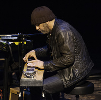 Daniel Lanois, playing pedal steel guitar during a concert at the BAM Howard Gilman Opera House in Brooklyn on April 12, 2014.