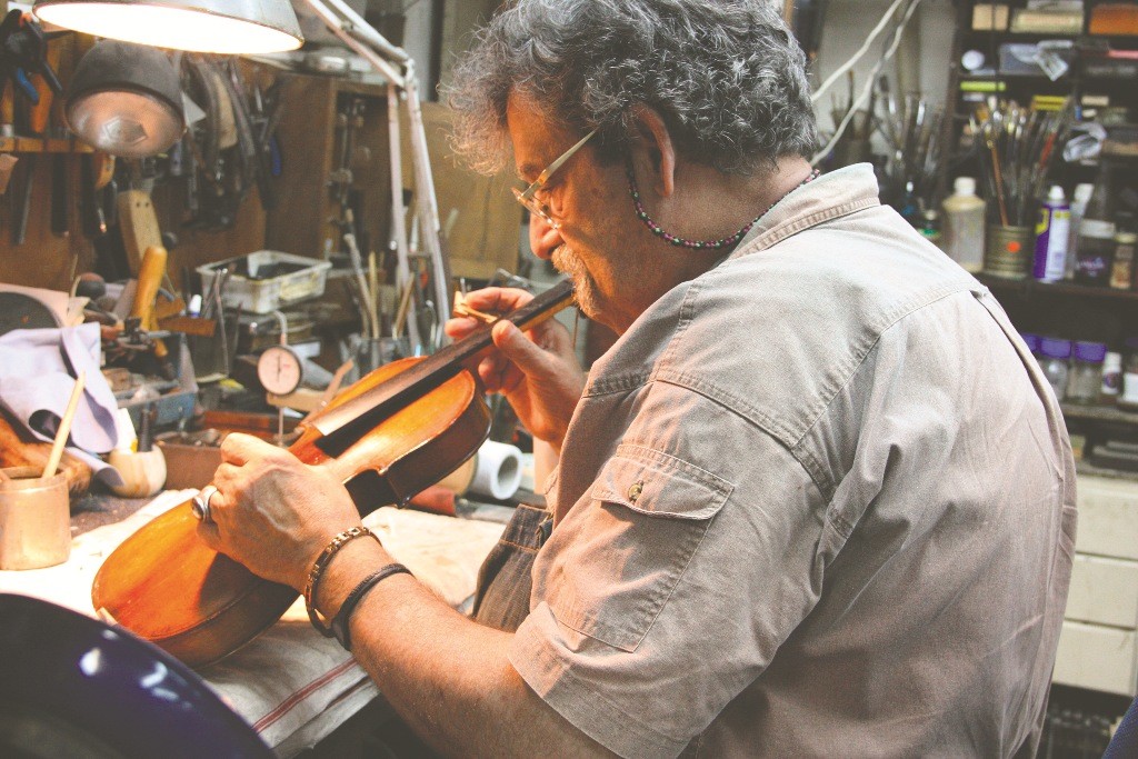 Amnon Weinstein repairing a violin in his Tel Aviv workshop.
