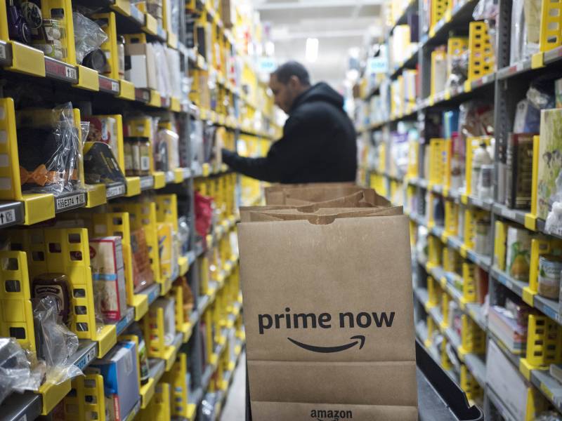 A clerk picks an item for a customer order at the Amazon Prime warehouse in New York. 