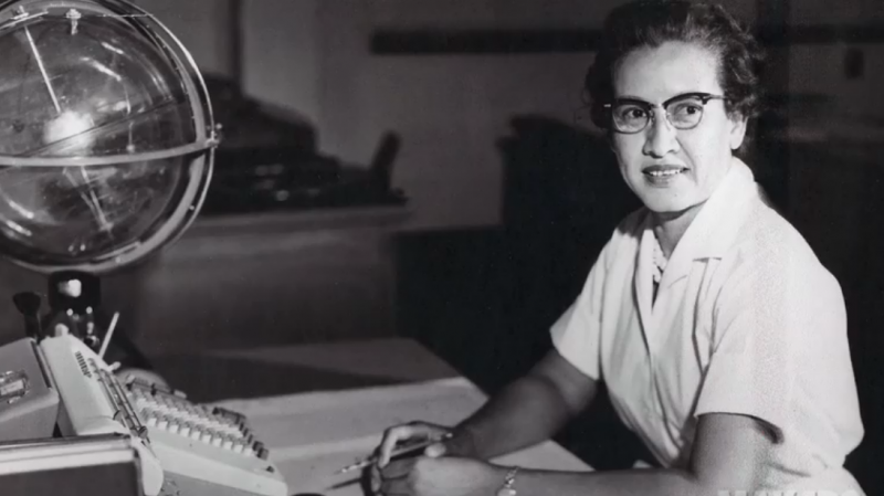 Johnson at her desk at NASA's Langley Research Center with a globe, or "Celestial Training Device."
