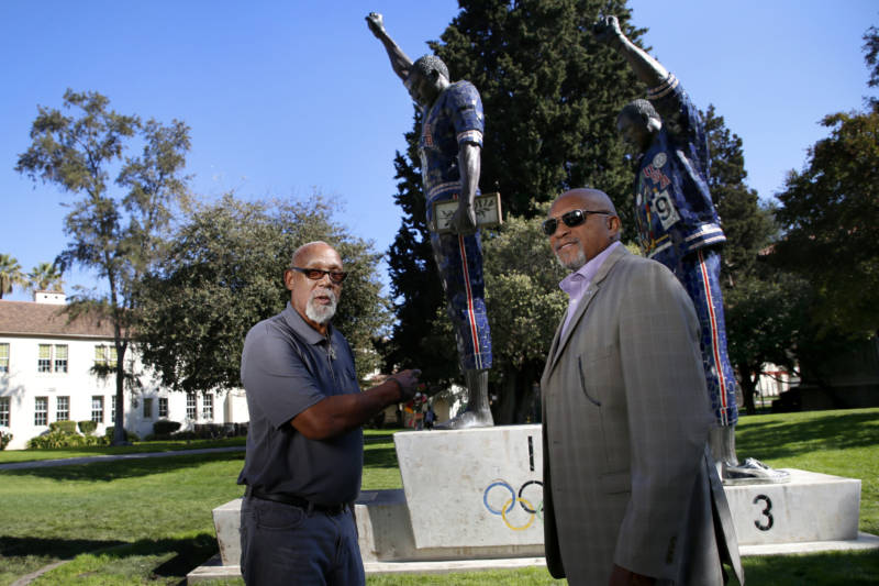 John Carlos (L) and Tommie Smith (R) stand in front of a statue on the San Jose State University campus memorializing their iconic act of protest at the 1968 Olympic Games in Mexico City. (Courtesy of Josie Lepe/San Jose State University)