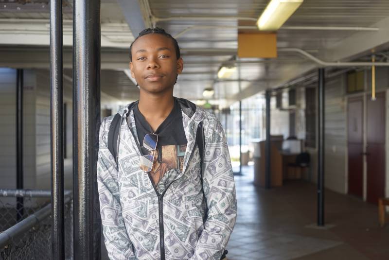 Dwayne, a senior at McClymonds stands in the hallway at Ralph J. Bunche Academy in West Oakland