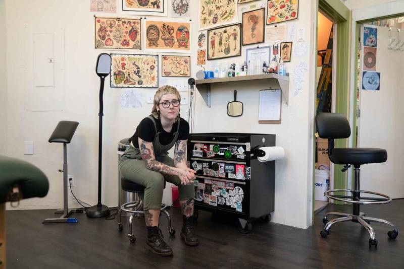 Emma Pierce at her station, which has been empty since the shutdown closed the tattoo shop where she works.