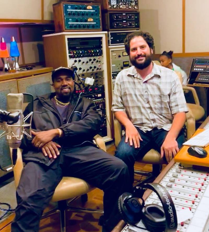 Kanye West with Hyde Street Studios engineer Will Chasen in a recording studio with a mixing console.