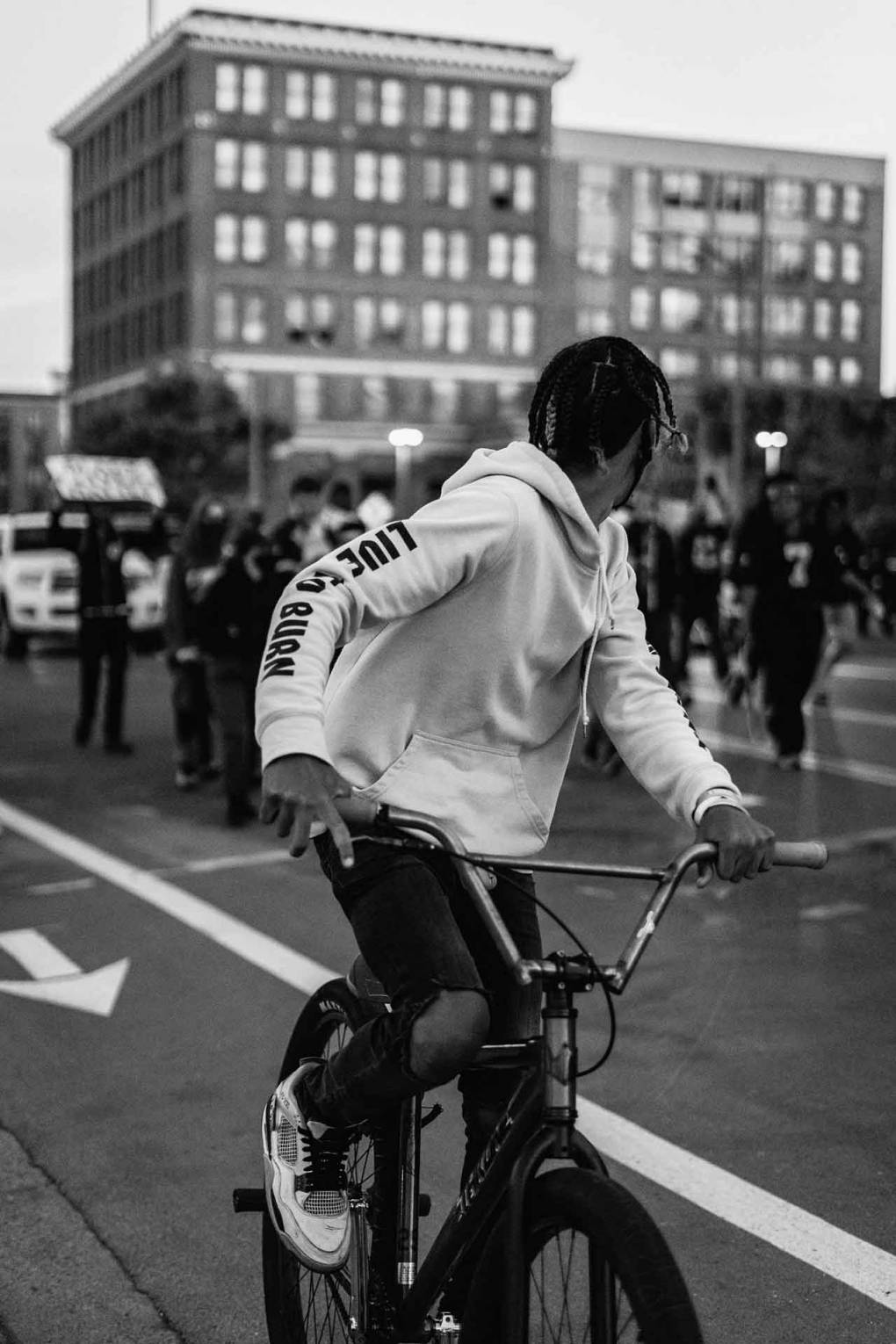 A cyclist amidst a protest in downtown Oakland during the final weekend of May 2020. Photographer Brandon Ruffin says he was hit with rubber bullets and subject to tear gas while taking these photos. 