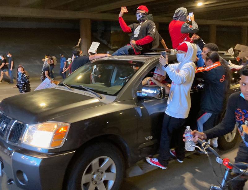 A car of protesters drives beneath the downtown mall in Santa Rosa on Saturday, June 2.
