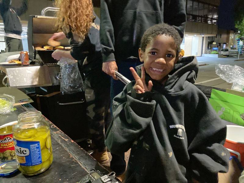 Kamari Houston, 5, helps serve food in Santa Rosa on Friday, June 5. He’s talked his mother Onjelle into coming out each night: "He seen it on the news and told me ‘Mama, I have to go out there, I have to be a part of that.'"