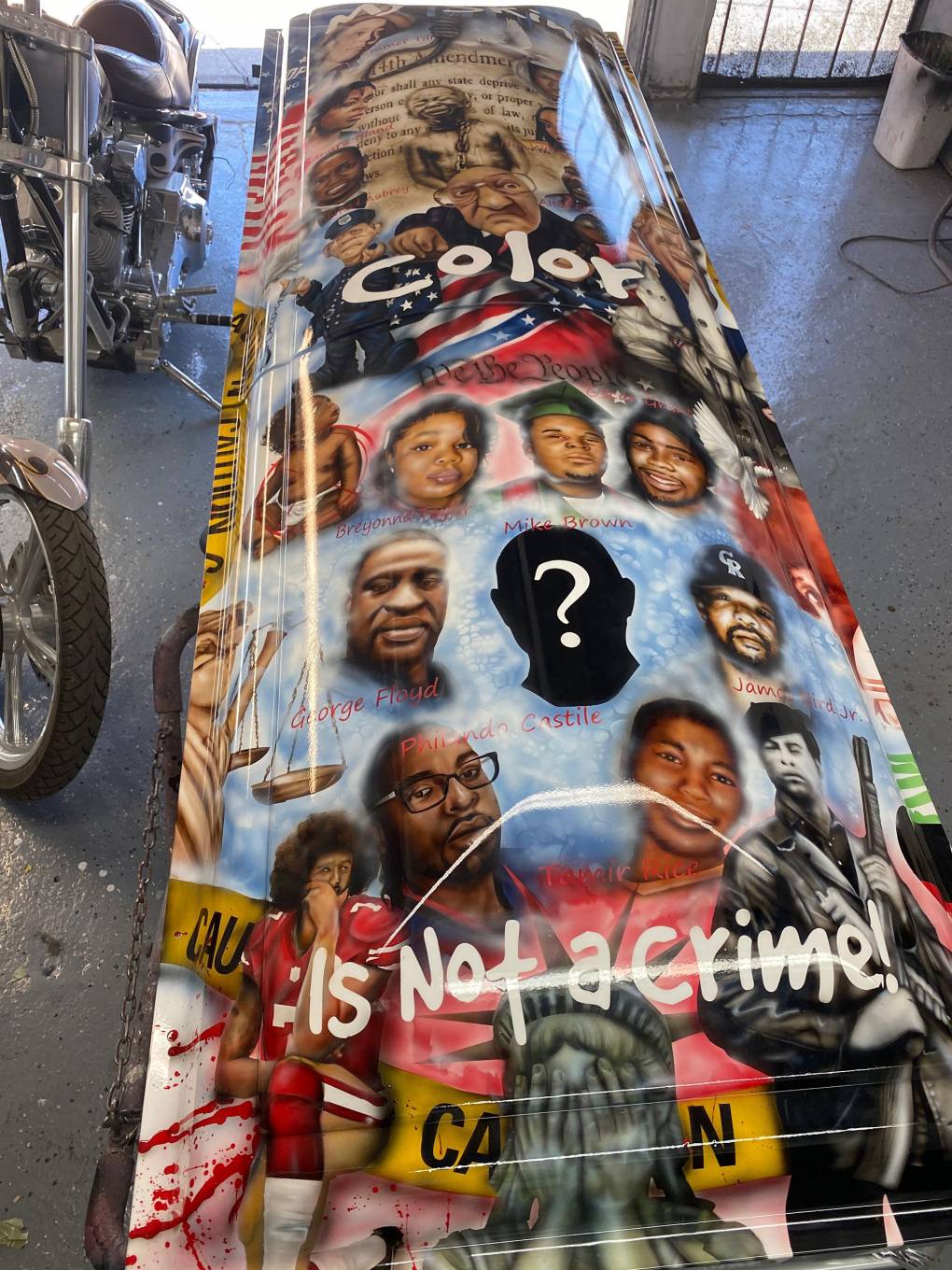 Sandra Bland, the 14th Amendment, an enslaved young man, Trayvon Martin and Nia Wilson all grace the casket created by DeAndre Drake. 