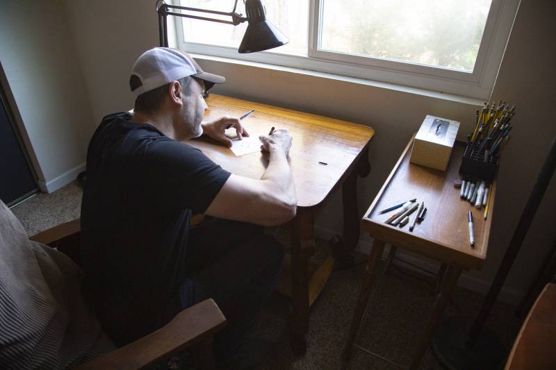 Stephan Pastis draws a quick sketch at his studio on Saturday, Sept. 19, 2020. The cartoonist prefers to work on a flat surface using a short chair. 
