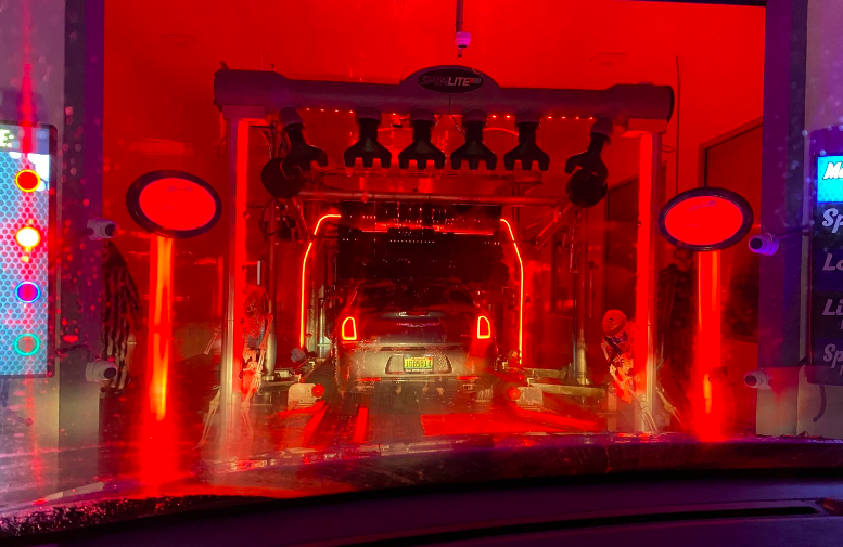 The entrance to a red-lit haunted car wash.
