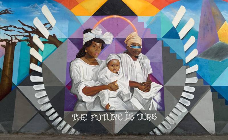 A mural on 14th Street in West Oakland, depicting Jazz Hudson, Olafemi Akintunde and their son Selah.