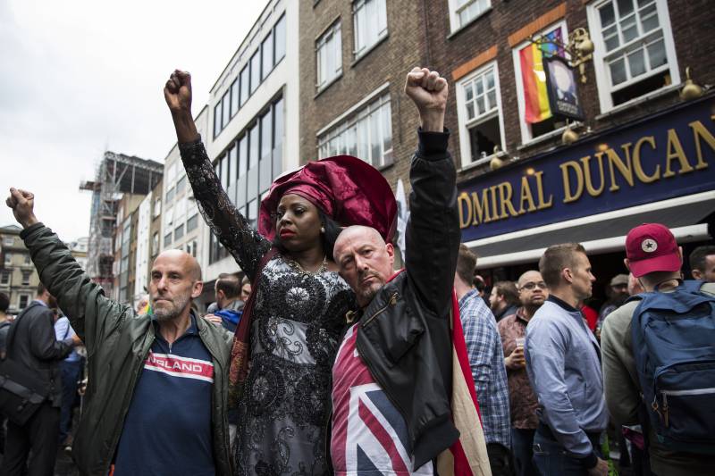 Londoners, gathered outside the Admiral Duncan pub as part of a vigil for the victims of the Pulse nightclub mass shooting in Florida, June 2016.