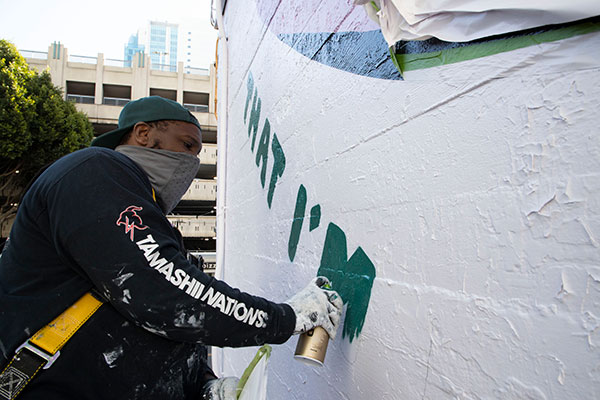The mural being painted.