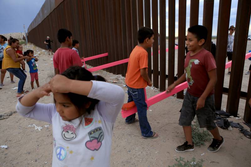 American and Mexican families play with a see-saw installation at the border near Ciudad Juarez, Mexico, in July of 2019. The project has been recognized by a prestigious design award.
