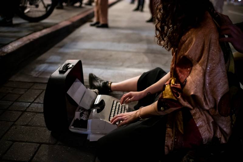 Deborah Drozd writes on a typewriter during a vigil for Lawrence Ferlinghetti at City Lights Books on Feb. 23, 2021.