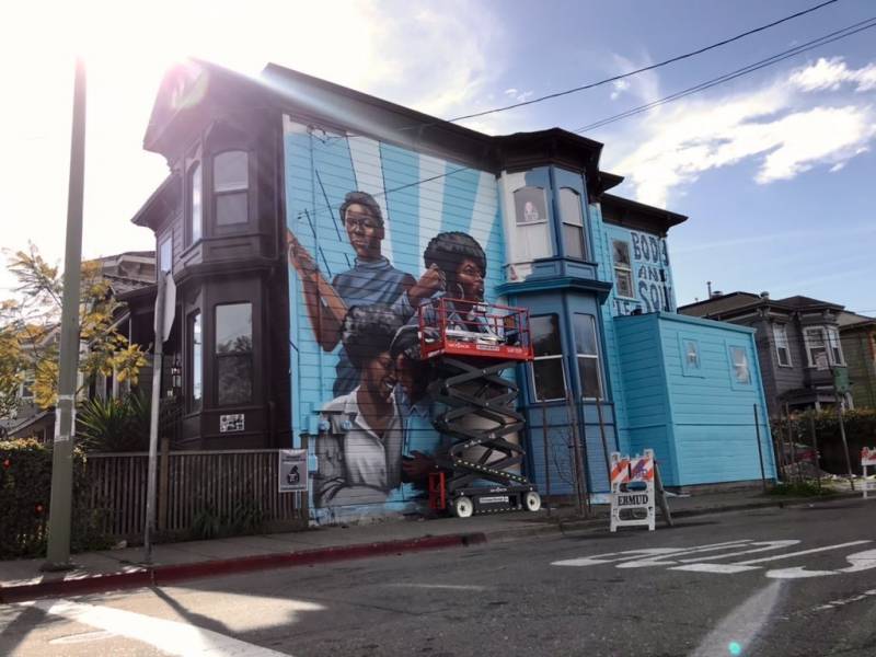 A two-story home on Center street and 9th street in West Oakland is now home to a mural dedicated to the women of the Black Panther Party. Artwork by Rachel Wolfe-Goldsmith. 