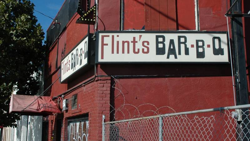 The exterior of Flint's Barbecue, with the "Flint's Bar-B-Q" sign visible