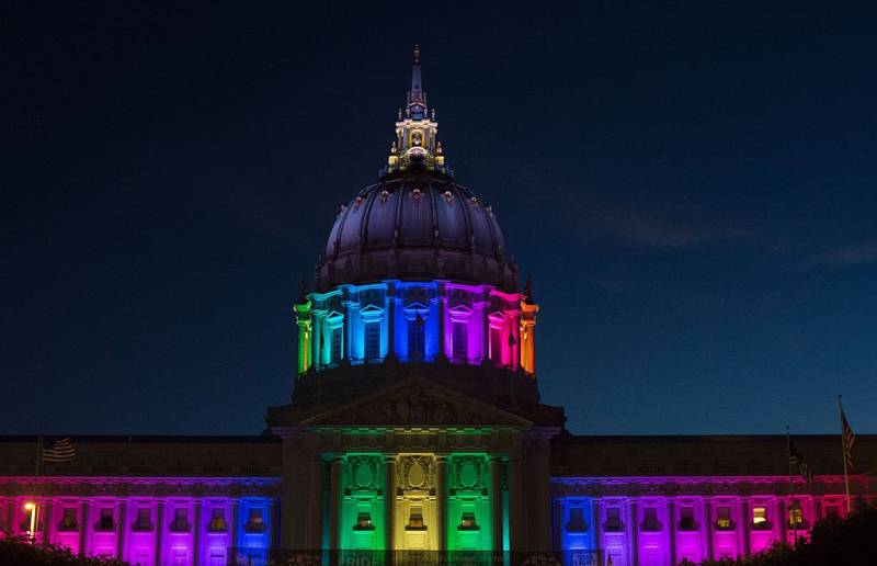San Francisco City Hall is lit up with rainbow colors.