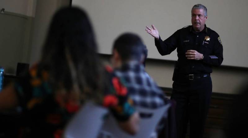 Oakland School Police chief Jeff Godown (R) talks with Oakland Unified School District staff during an active shooter training in 2018. 
