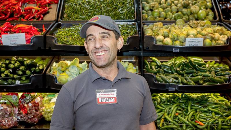 Community Foods CEO Brahm Ahmadi poses in the produce section