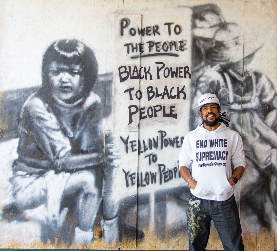 Khafre Jay at a mural he recently restored in Oakland's Chinatown.