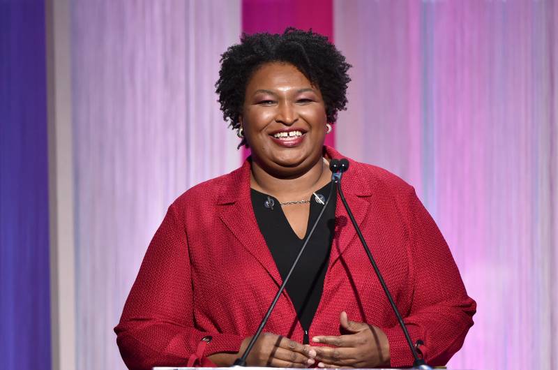 Stacey Abrams smiles at a 'Hollywood Reporter' event, 2019.