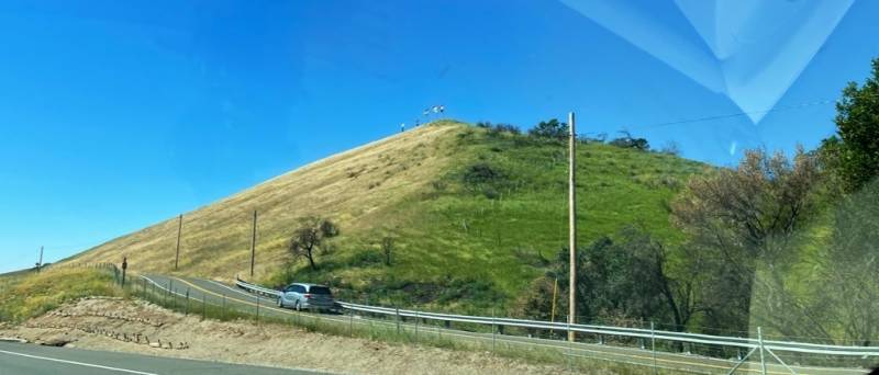 The grass on hill near Cherry Glen Road in Vacaville, turning from green to brown.