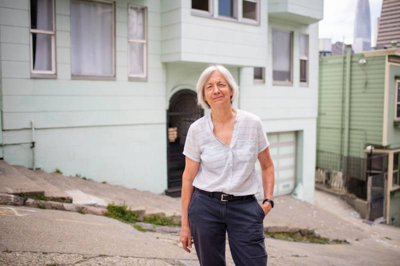 Lynn Painter, one of the hosts in the Host Homes program, stands in front of her house in San Francisco.