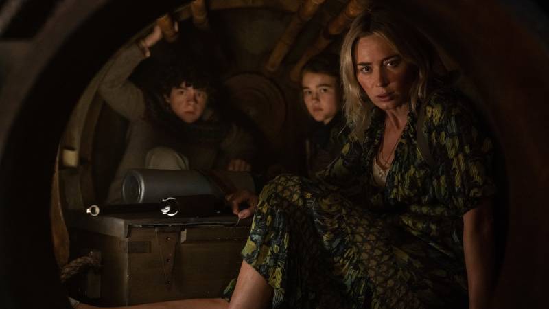 Marcus (Noah Jupe), Regan (Millicent Simmonds) and Evelyn (Emily Blunt) huddle together in an enclosed space in 'A Quiet Place Part II.'