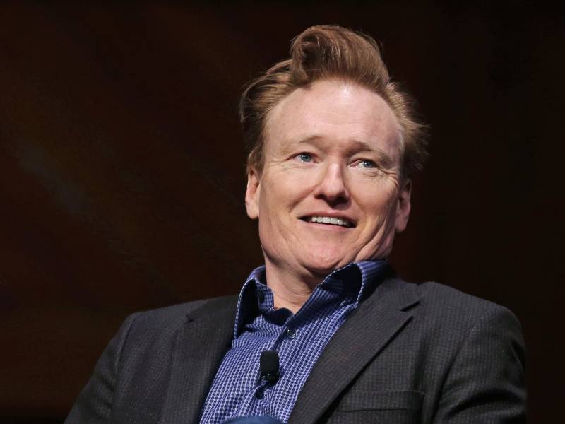 Conan O'Brien smiles towards an audience at Harvard University—his alma mater—in 2016.