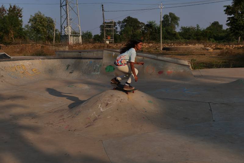 Asha Gond rides over an obstacle known as a volcano at the Janwar Castle skatepark in her village.