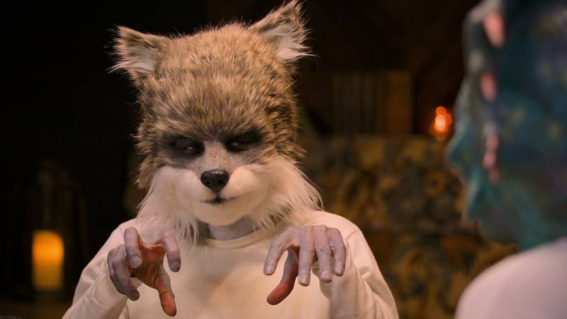 A man wearing a cute and furry wolf's head. He is one of the participants on the coming Netflix series 'Sexy Beasts.' We're as confused as you are.