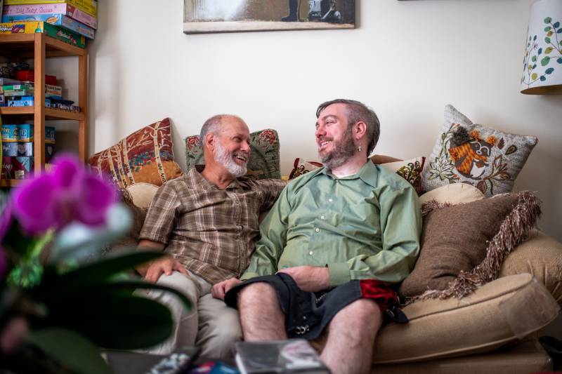 Erik Green (left) and Ron Frost share a moment on the couch. 