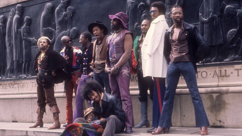 LIVERPOOL, ENGLAND - MAY 1971: (L-R) Fuzzy Haskins, Tawl Ross, Bernie Worrell, Tiki Fulwood, Grady Thomas, George Clinton, Ray Davis, Calvin Simon and seated Eddie Hazel and Billy "Bass" Nelson of the funk band Parliament-Funkadelic pose for a portrait in May 1971 in Liverpool, England. (Photo by Michael Ochs Archives/Getty Images)