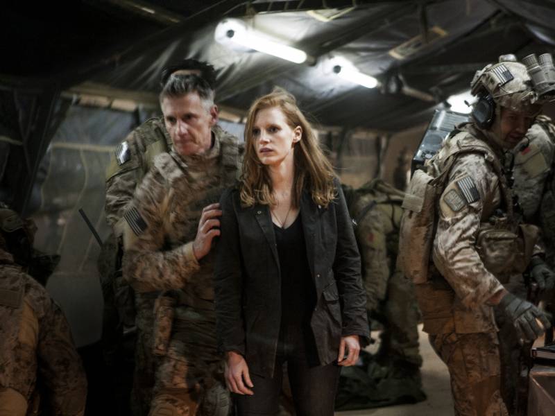 Stationed at a covert base overseas, Maya (Jessica Chastain) is a member of the elite team of spies and military operatives (Christopher Stanley, left, and Alex Corbet Burcher, right) who devote themselves to finding Osama bin Laden in 'Zero Dark Thirty.'