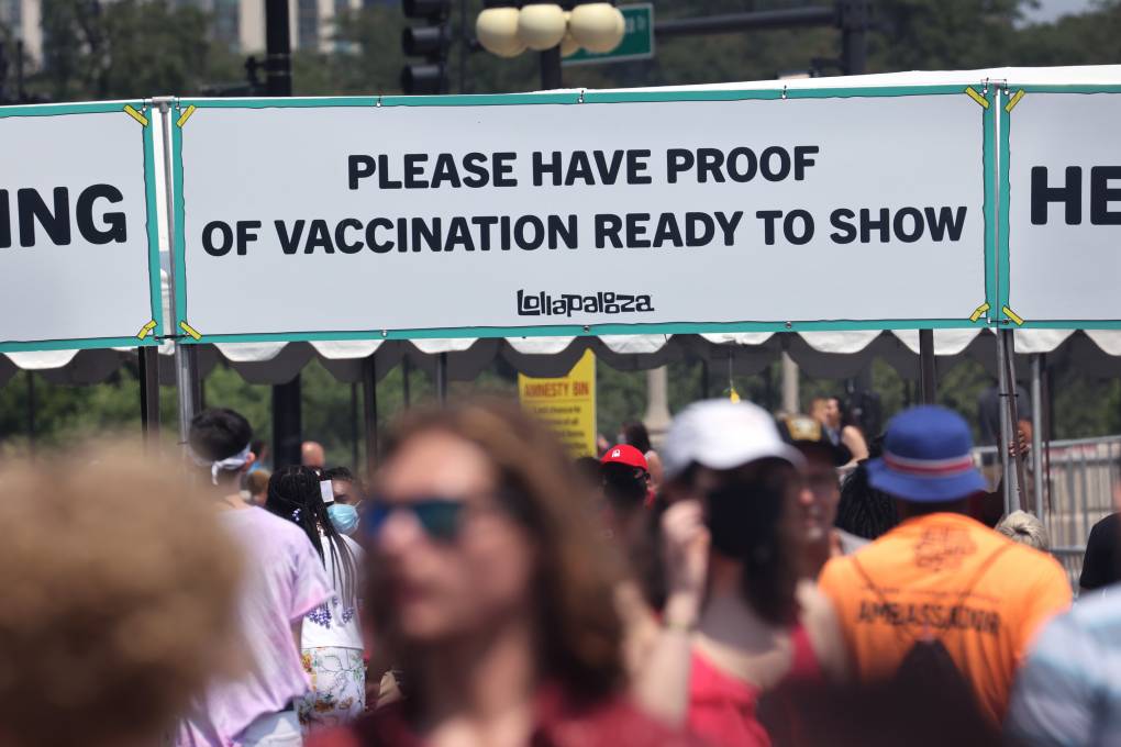 A barrier at the Lollapalooza festival in Chicago reads "Please have proof of vaccination to show."
