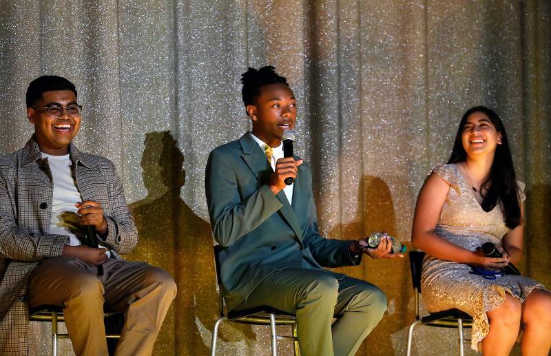 Dwayne Davis holds the microphone as he sits on a panel between Denilson Garibo and Jessica Ramos, discussing the film Homeroom. 