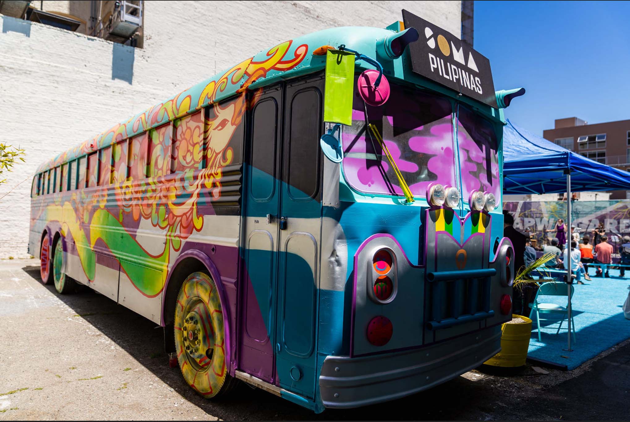 Colorfully painted bus with a "SOMA Pilipinas" sign in front.
