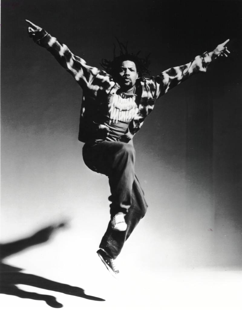 Black and white photo of Rennie Harris captured mid-jump.