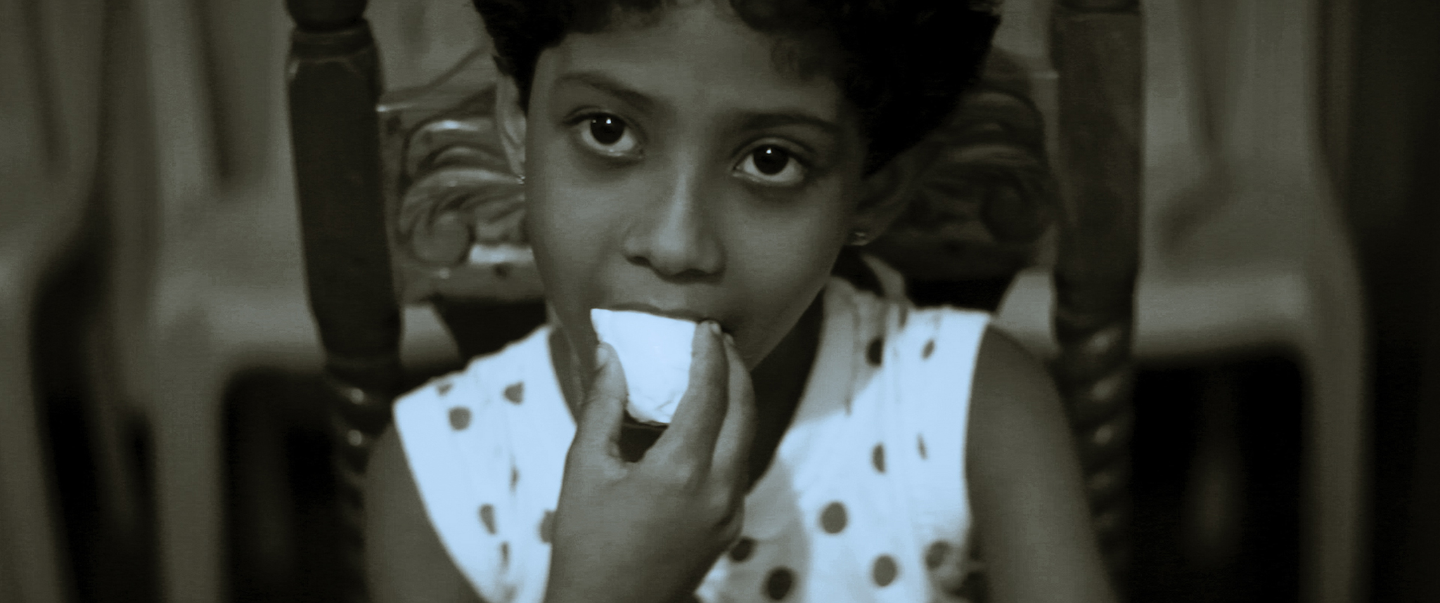 A child eats a piece of food.