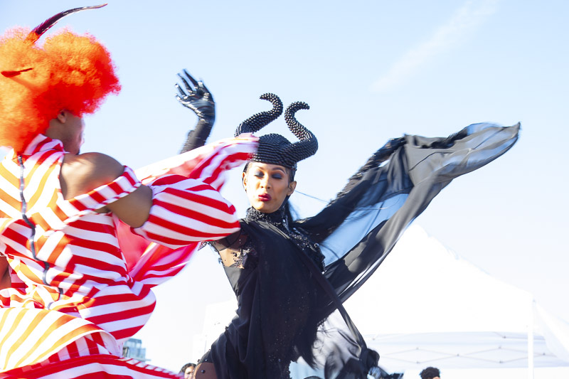Dancers in elaborate costumes face each other.