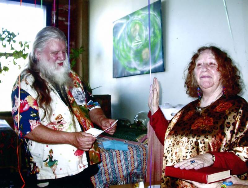Last Gasp founder Ron Turner 'swears in' Diane di Prima in a mock ceremony, with her hand on a volume of Keats, in 2009 in the old Sears building in the Mission DIstrict of an Francisco.
